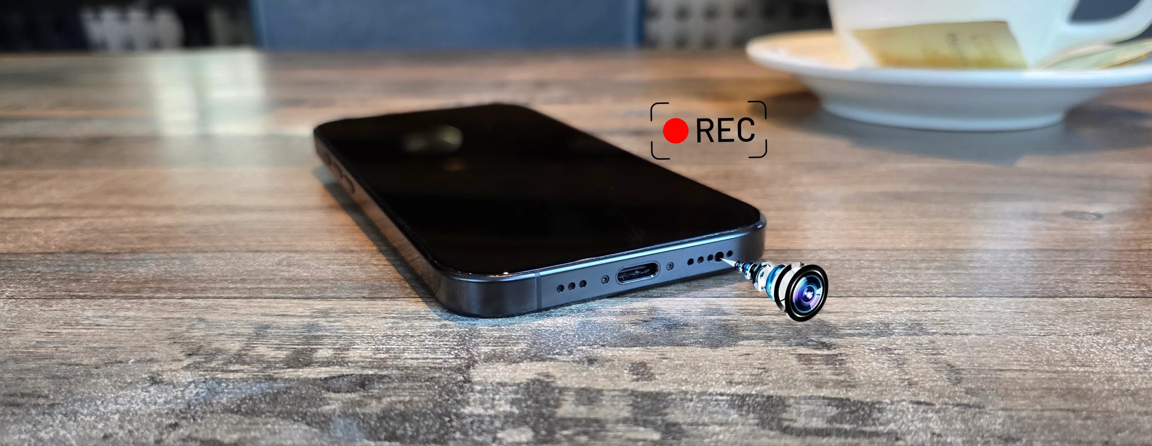 Tenthousandcam hidden camera phone with front camera relocated to bottom speaker hole, black screen recording on table for discreet evidence capture