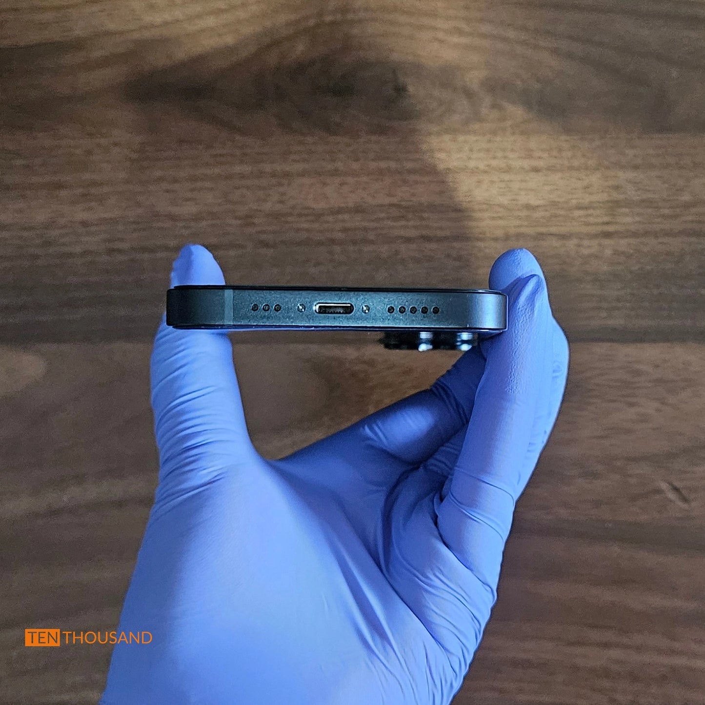 Bottom view of iPhone 14 hidden camera phone showing original speaker and charging port layout unchanged