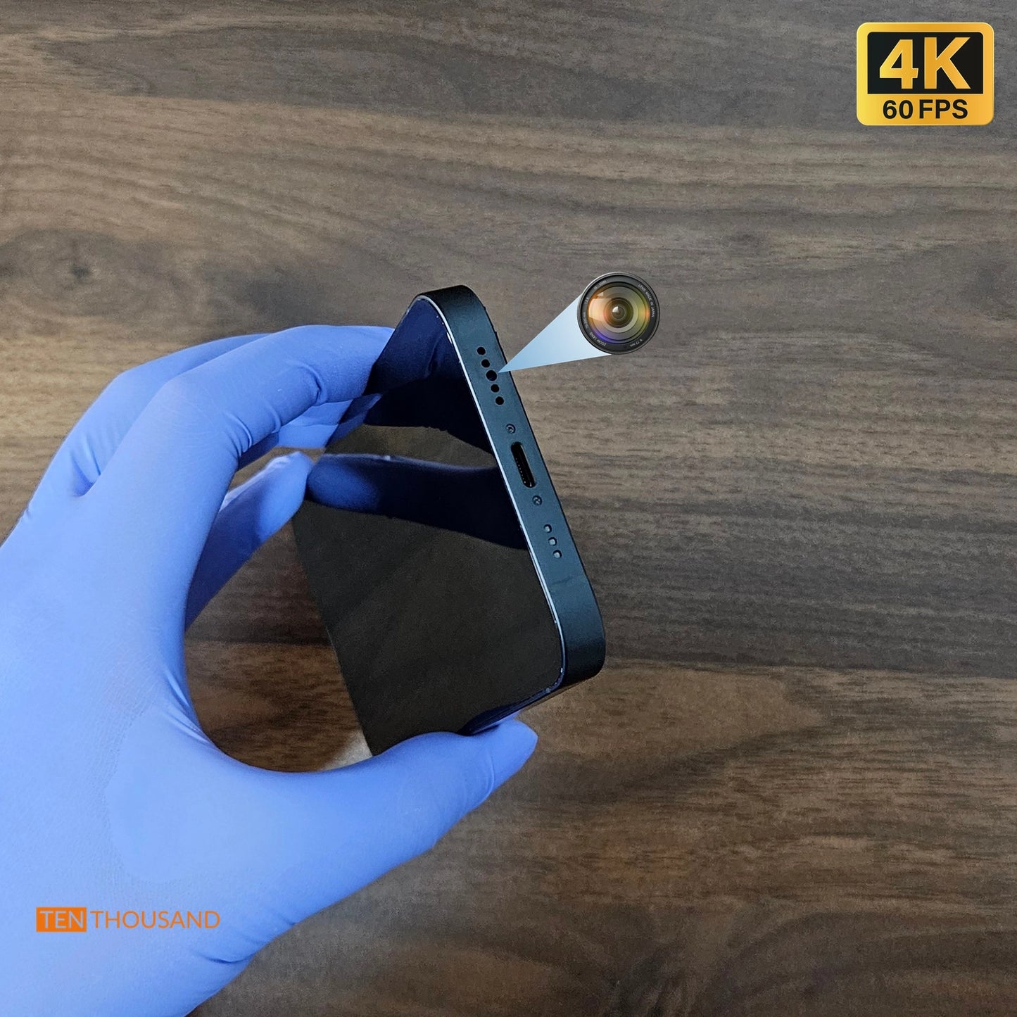 Close-up view of iPhone 14 with front camera relocated to the bottom speaker hole for discreet recording